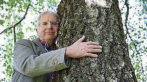 Pierre Stutz umarmt einen Baum. | © Andrea Göppel